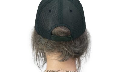 Back view of a person wearing a black cap and white shirt.