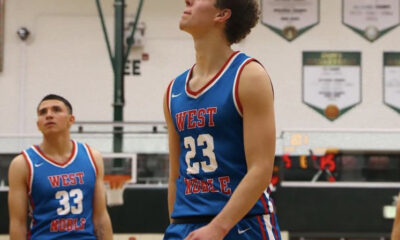 Basketball player in blue jersey looking up during a game.