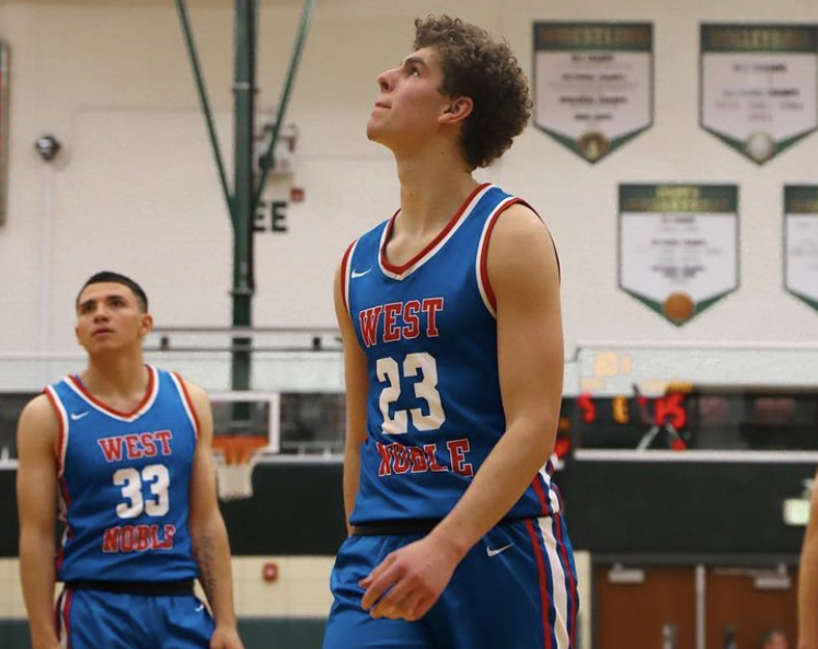 Basketball player in blue jersey looking up during a game.
