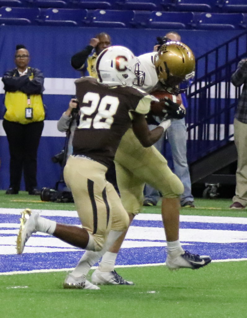 Football players in action during a game on the field.
