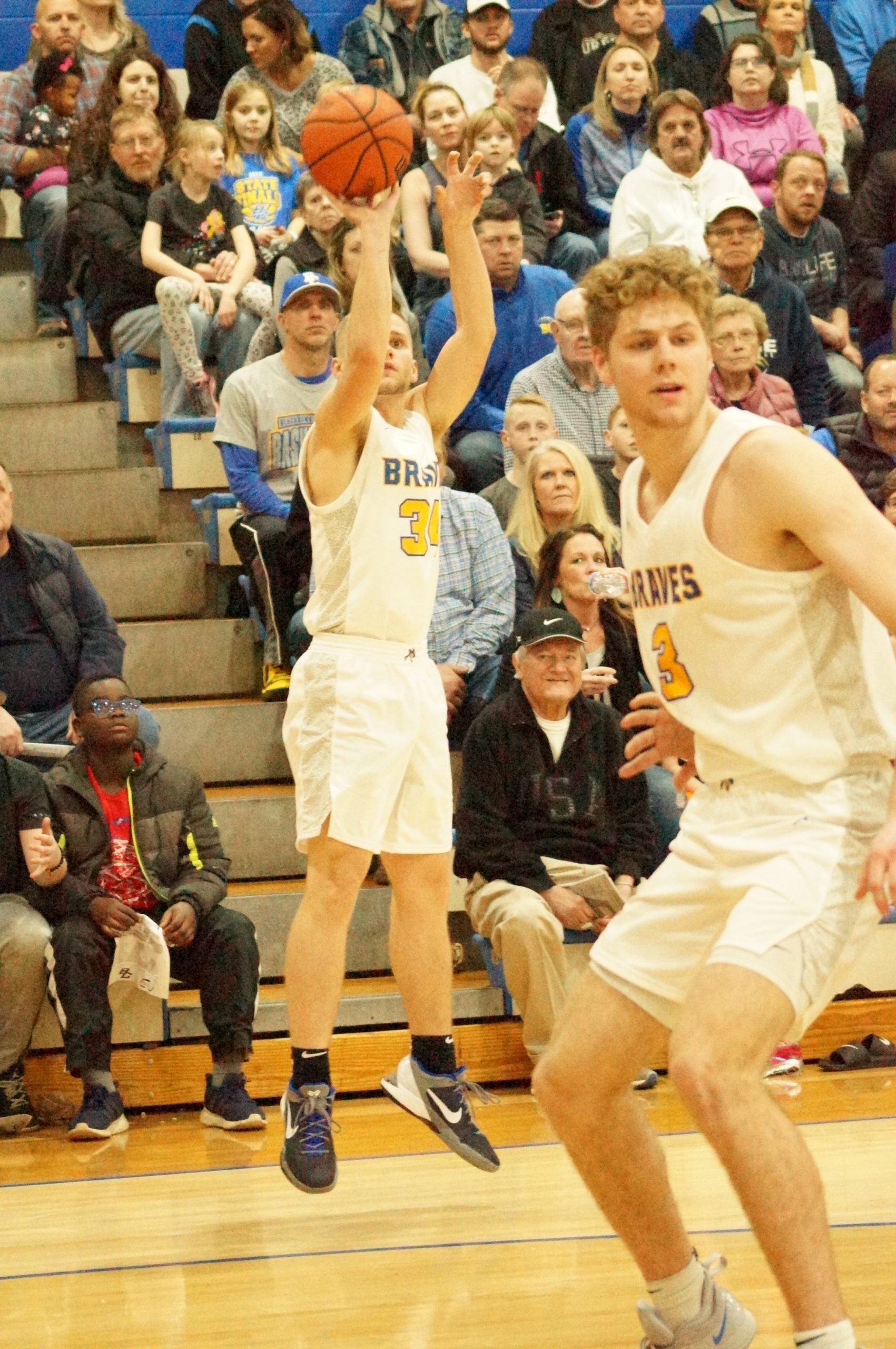 Basketball player shooting a jump shot during a game.