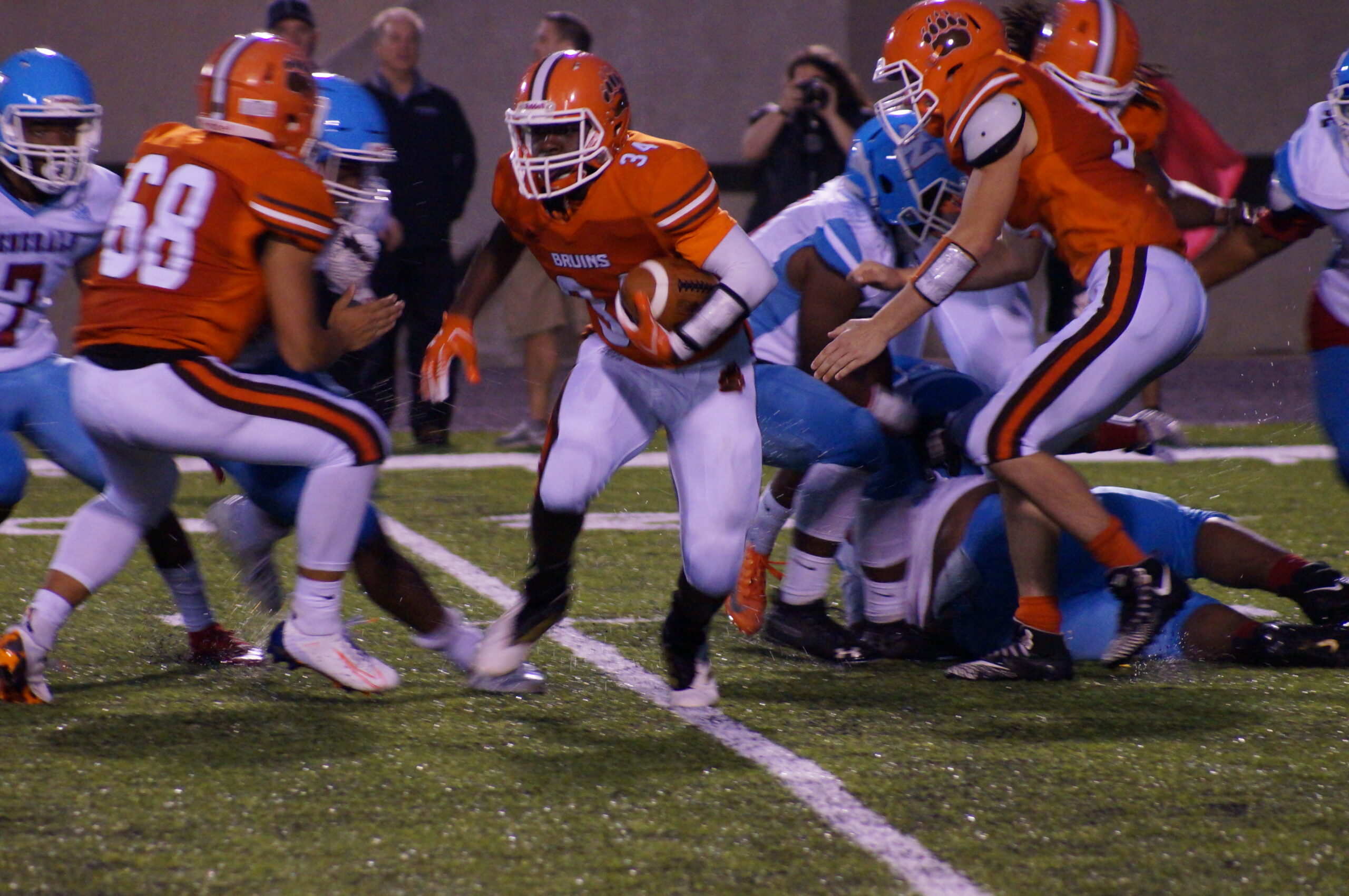 Football players in action during a game on the field.
