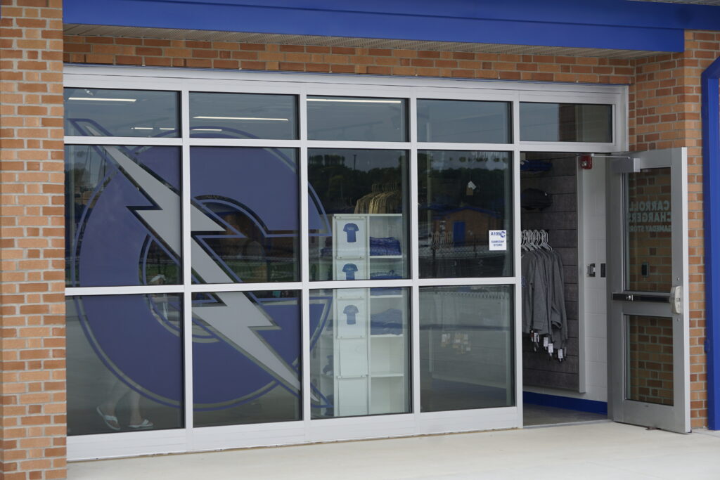 Exterior glass window with a large lightning bolt graphic and visible interior items.