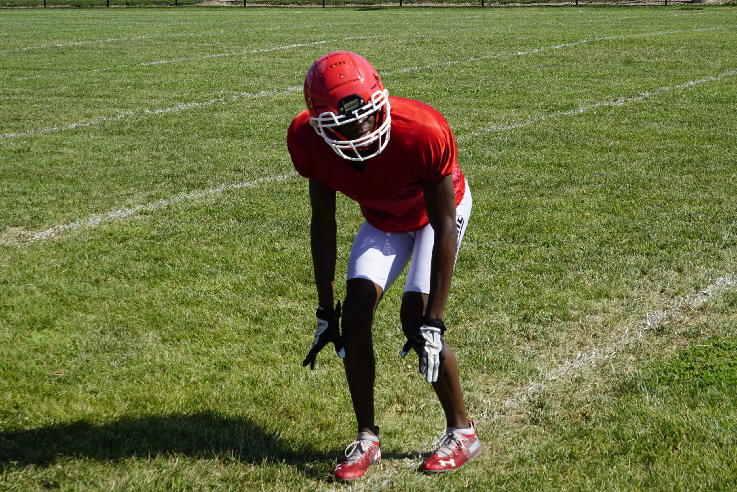 Football player in a red jersey ready for action on the field.