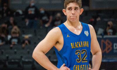 Basketball player in a blue Blackhawk Christian jersey with number 32.