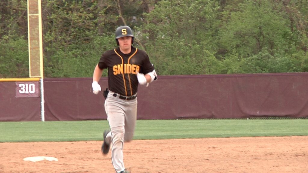 Baseball player running on the field during a game.