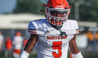 Football player wearing a red helmet and white jersey with number 3.